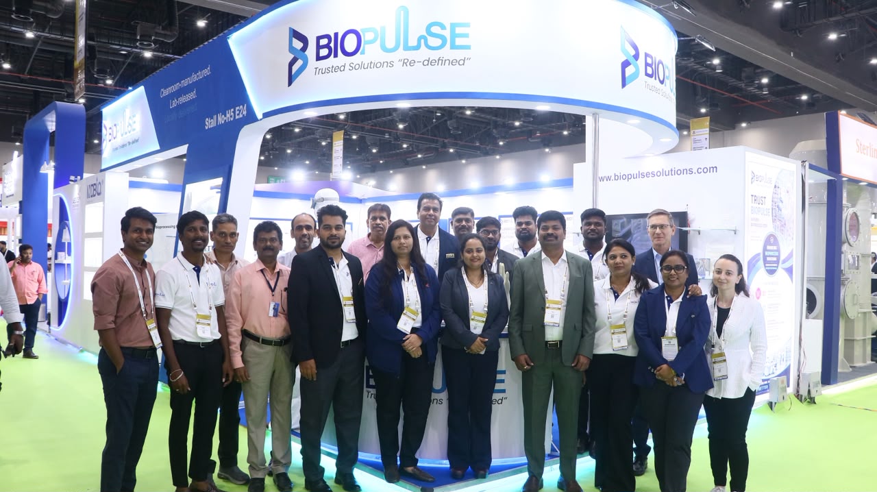 BioPulse team in front of the branded BioPulse Solutions exhibition booth