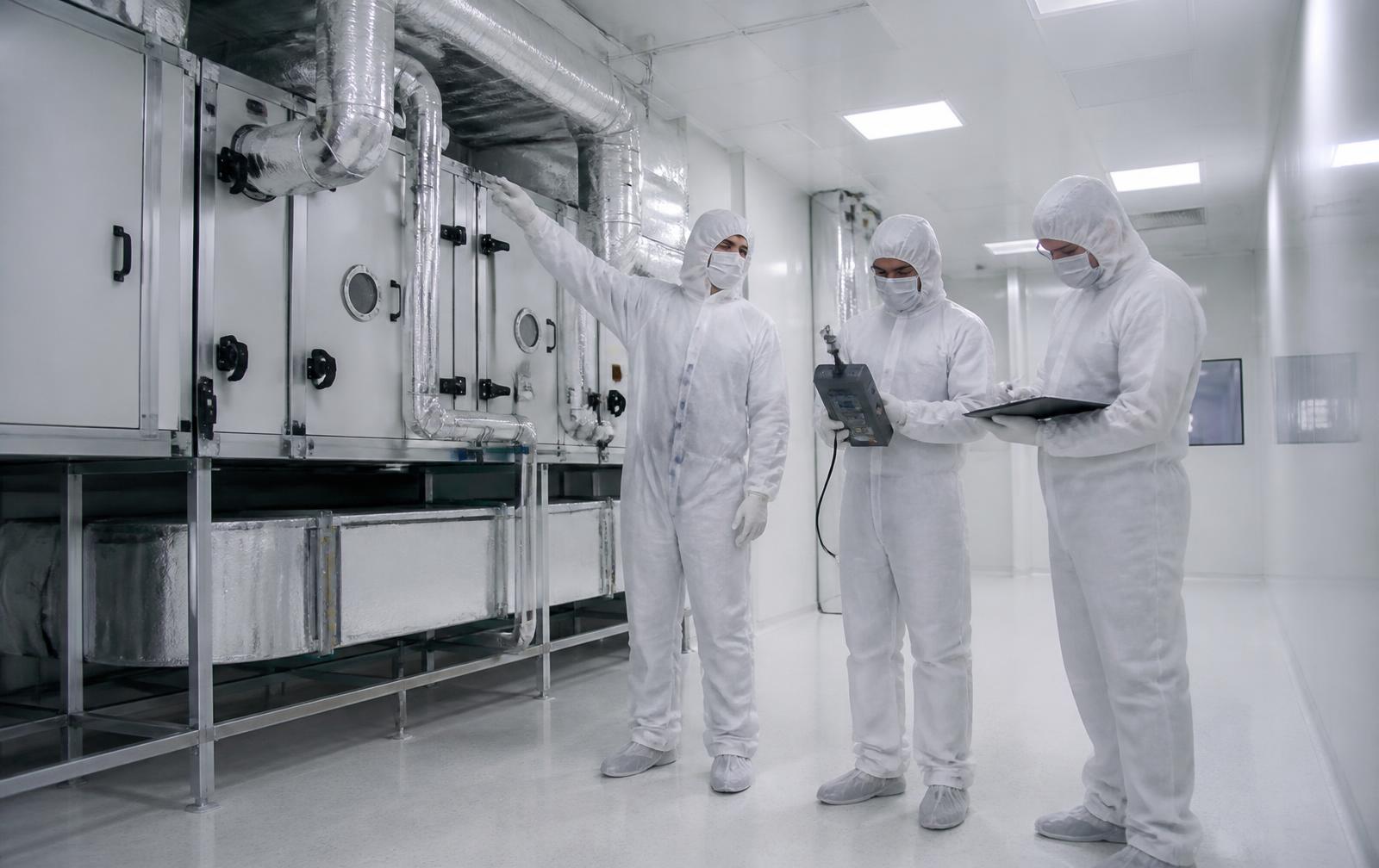 Engineers performing cleanroom HVAC commissioning and airflow validation
